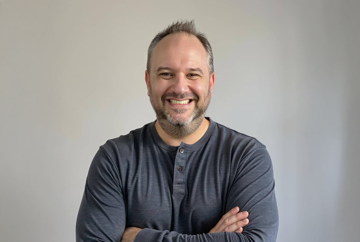 Darren Beason smiling with arms crossed